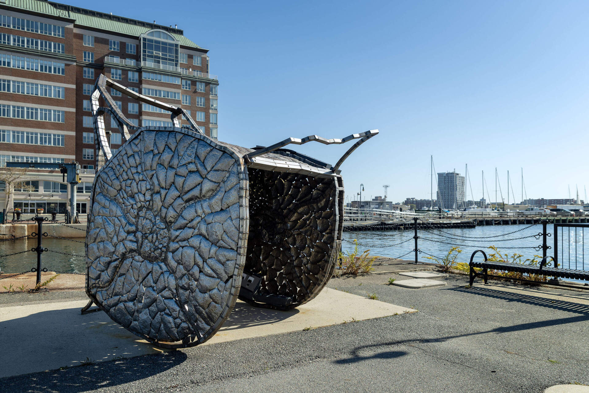"Nomad 2," a steel vessel shaped like a whale vertebra by Beatriz Cortez, sits at the end of a wharf at the Charlestown Navy Yard. (Robin Lubbock/WBUR)