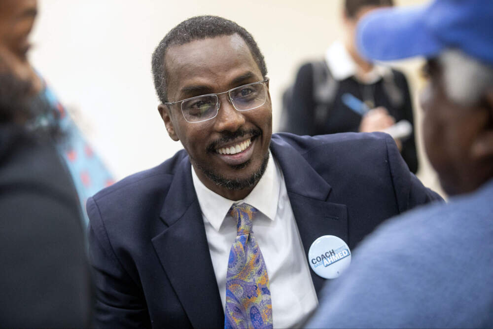 Said Ahmed, a candidate for Boston city council District 7, talks with audience members after a candidates forum at the Dudley Street Neighborhood Initiative. (Robin Lubbock/WBUR)