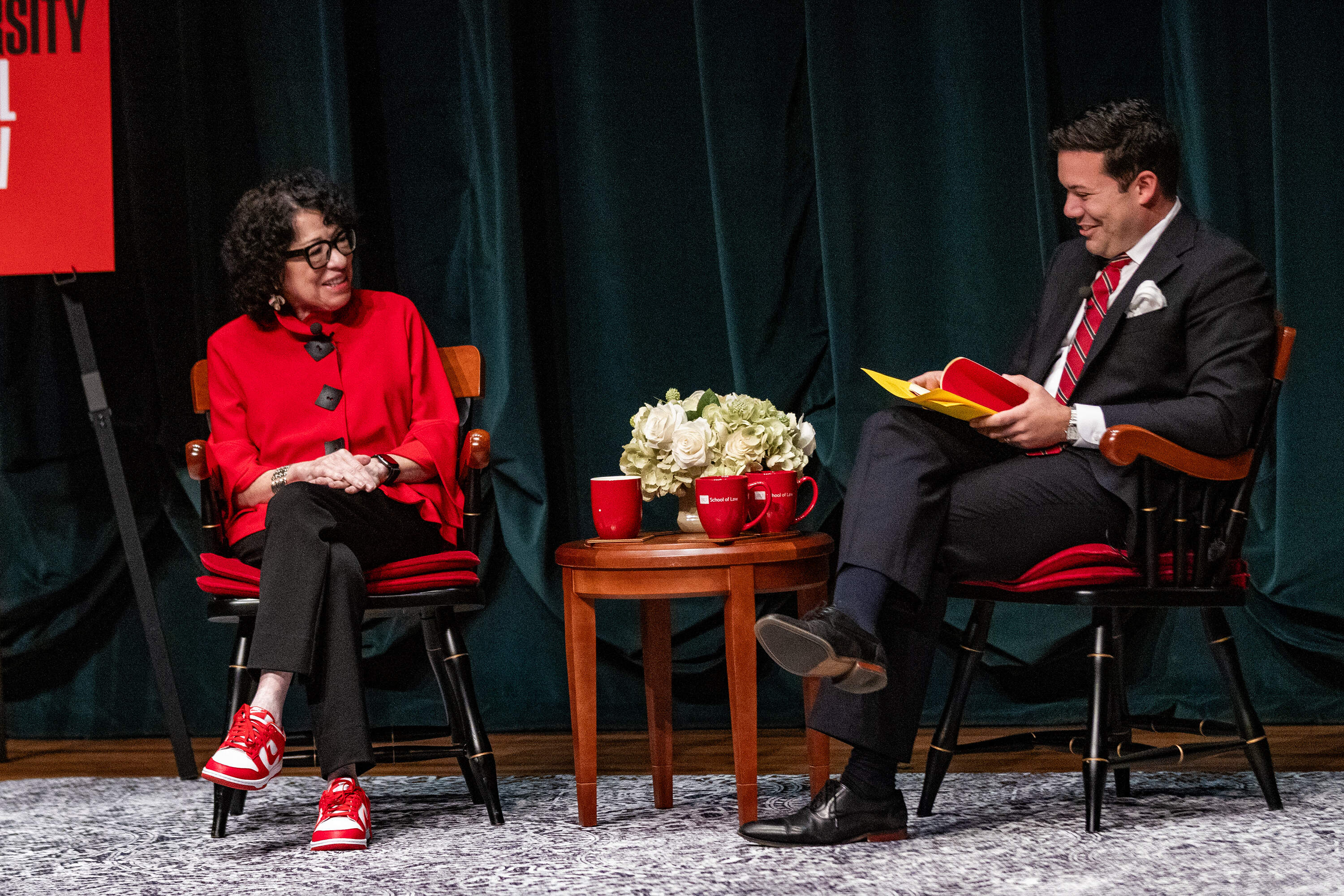 U.S. Supreme Court Justice Sonia Sotomayor smiles as her former law clerk and Boston University alumnus, Cesar Cesar Lopez-Morales, interviews her on Friday, Oct. 24. Sotomayor spoke about her life experiences that have shaped her work on the bench and gave advice to the roomful of law students. (Jesse Costa/WBUR)