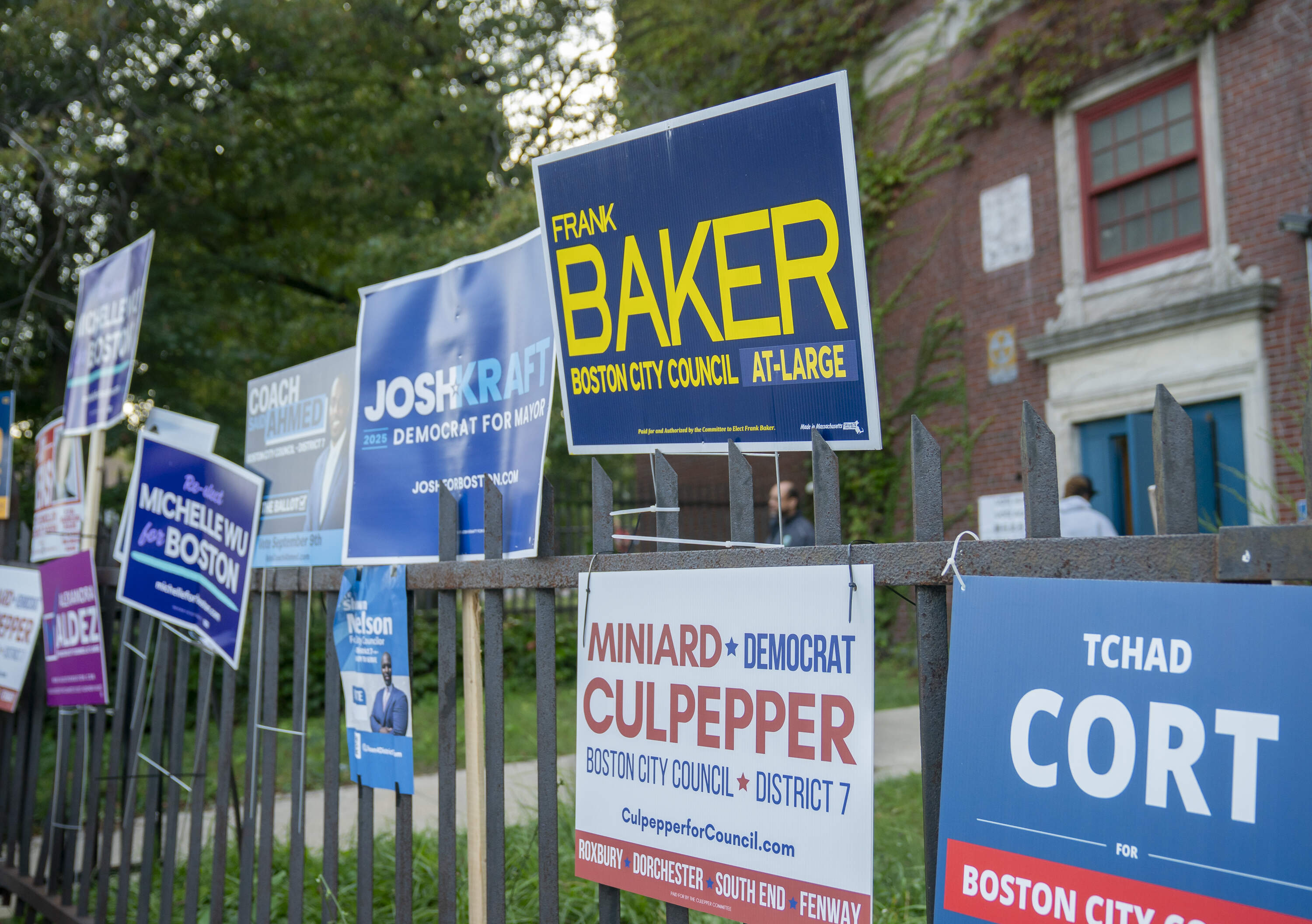 Candidate signs line a fence in Roxbury during Boston's preliminary election on Sept. 9. (Amanda Sabga for WBUR)