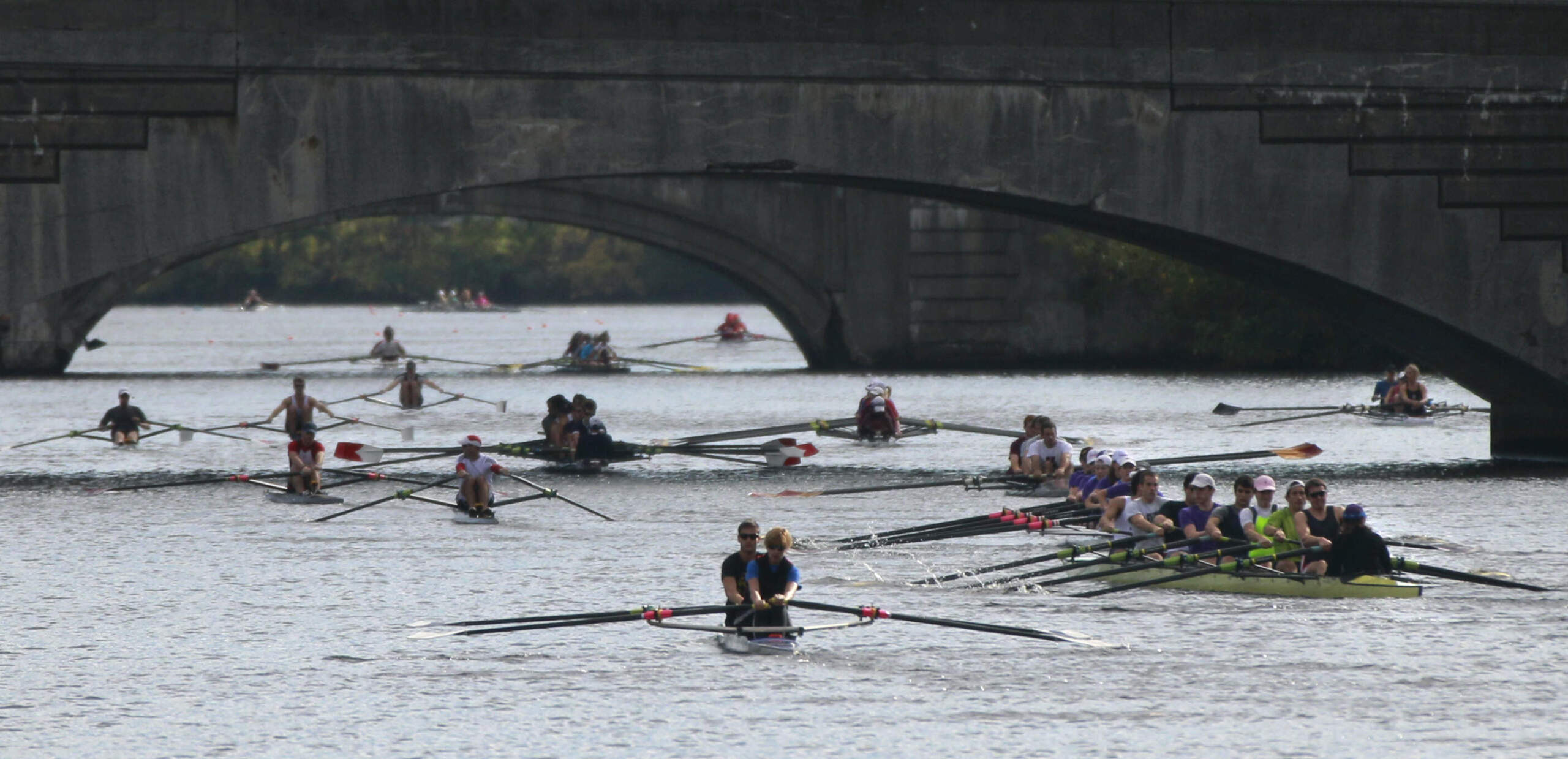 Boats negotiate the bridges on the Charles River during rowing practice for the Head of the Charles Regatta. (Elise Amendola/AP)