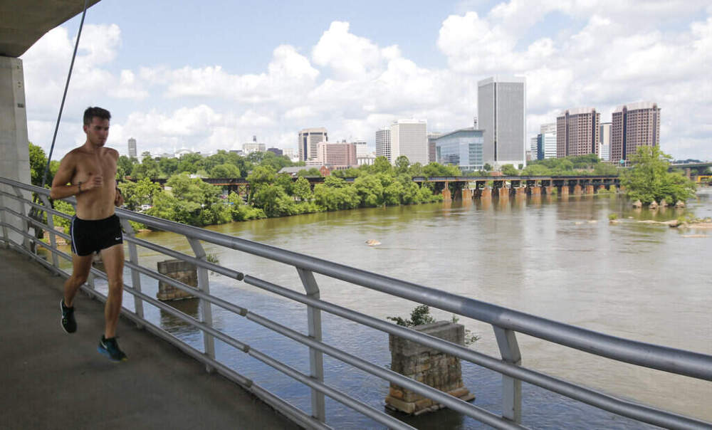 A runner jogs along a bridge over the James River near downtown Richmond, Virginia, on May 31, 2016. (Steve Helber/AP)