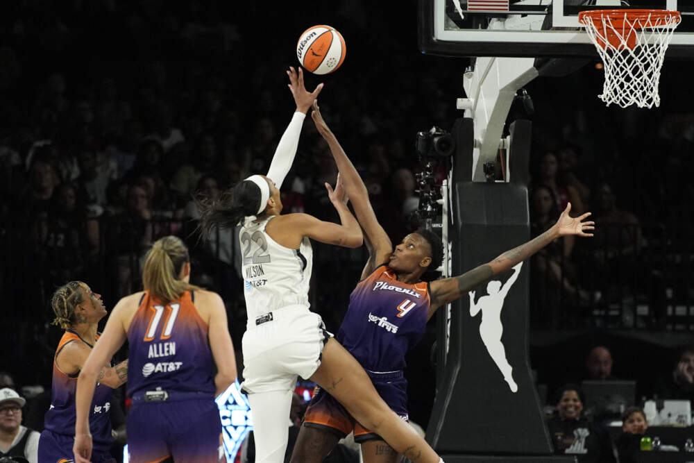 Phoenix Mercury forward Natasha Mack (4) guards Las Vegas Aces center A'ja Wilson (22) during the second half of a WNBA basketball game Tuesday, May 14, 2024, in Las Vegas. (John Locher/AP)