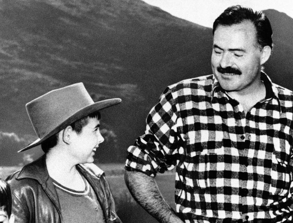 Patrick Hemingway, left, looks at his father, Ernest Hemingway, in Tanzania in 1940 (Nair, File/AP)