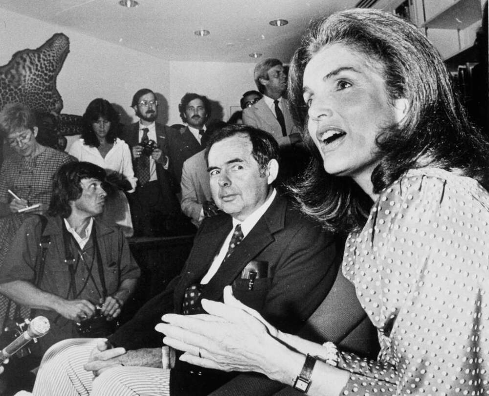 Patrick Hemingway, center, watches as Jacqueline Kennedy Onassis, right, talks to reporters at ceremonies marking the opening of the Ernest Hemingway Room at the John F. Kennedy Memorial Library in Boston on July 18, 1980. (Stu Rosner/AP)