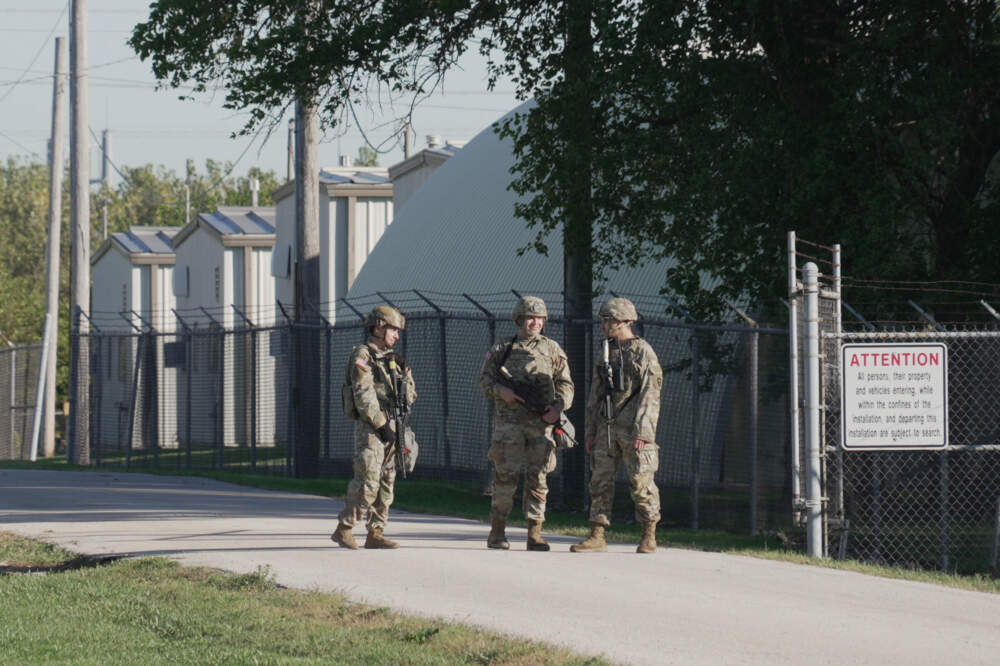 Military personnel in uniform, with the Texas National Guard patch on, are seen at the U.S. Army Reserve Center, Wednesday, Oct. 8, 2025, in Elwood, Ill., a suburb of Chicago. (Laura Bargfeld/AP)