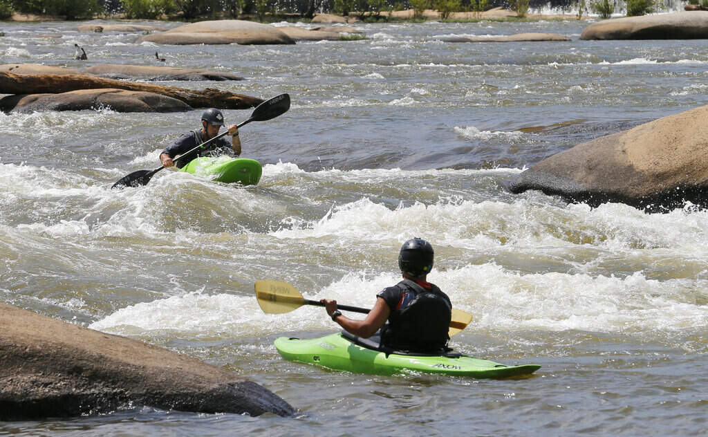 Kayakers run the rapids on the James River near downtown Richmond, Virginia, on Tuesday, May 31, 2016. (Steve Helber/AP)