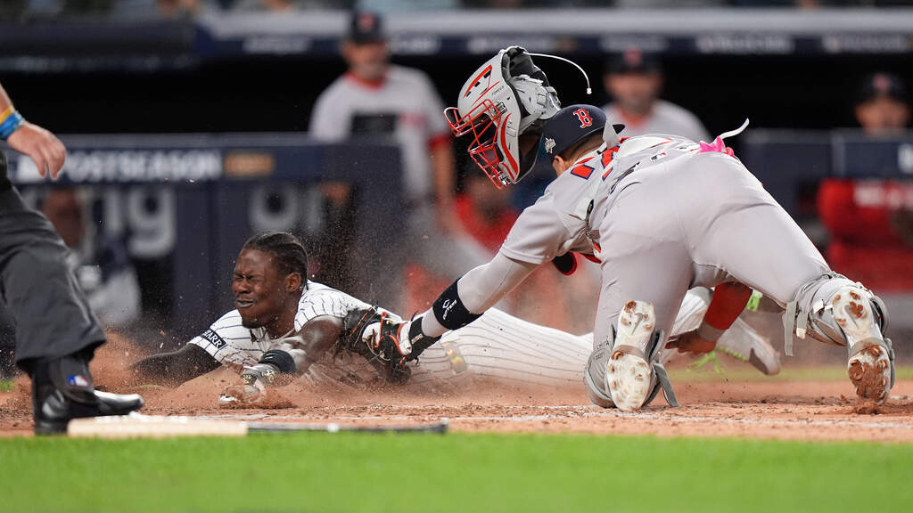 New York Yankees Jazz Chisholm Jr. slides safely into home plate ahead of the tag from Boston Red Sox catcher Carlos Narváez (75) during the eighth inning of Game 2 of an American League wild-card baseball playoff series, Wednesday, Oct. 1, 2025, in New York. (Frank Franklin II/AP)
