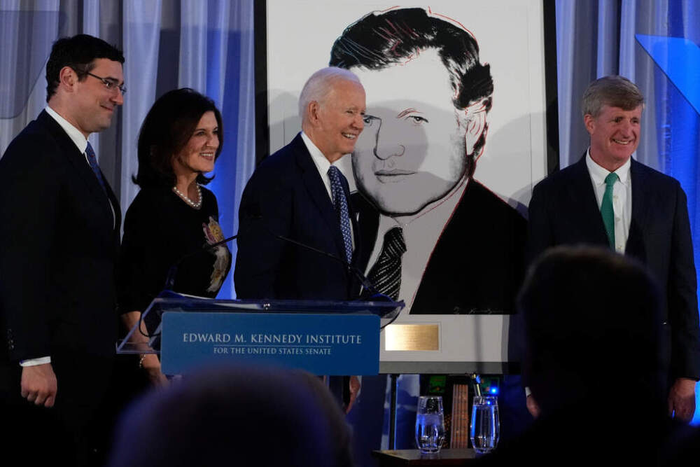 Former President Joe Biden is presented with the Lifetime Achievement Award by Victoria Reggie Kennedy, her son Curran Raclin, far left, and Patrick Kennedy, far right, in Boston. (Robert F. Bukaty/AP)