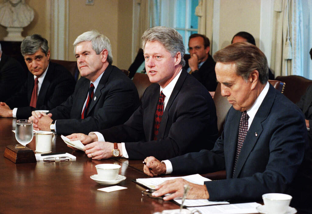 In this April 26, 1995 file photo, President Bill Clinton meets with congressional leaders in the Cabinet Room of the White House in Washington. From left are Treasury Secretary Robert Rubin, House Speaker Newt Gingrich of Ga., the president, and Senate Majority Leader Bob Dole of Kansas. (AP Photo/Marcy Nighswander, File)