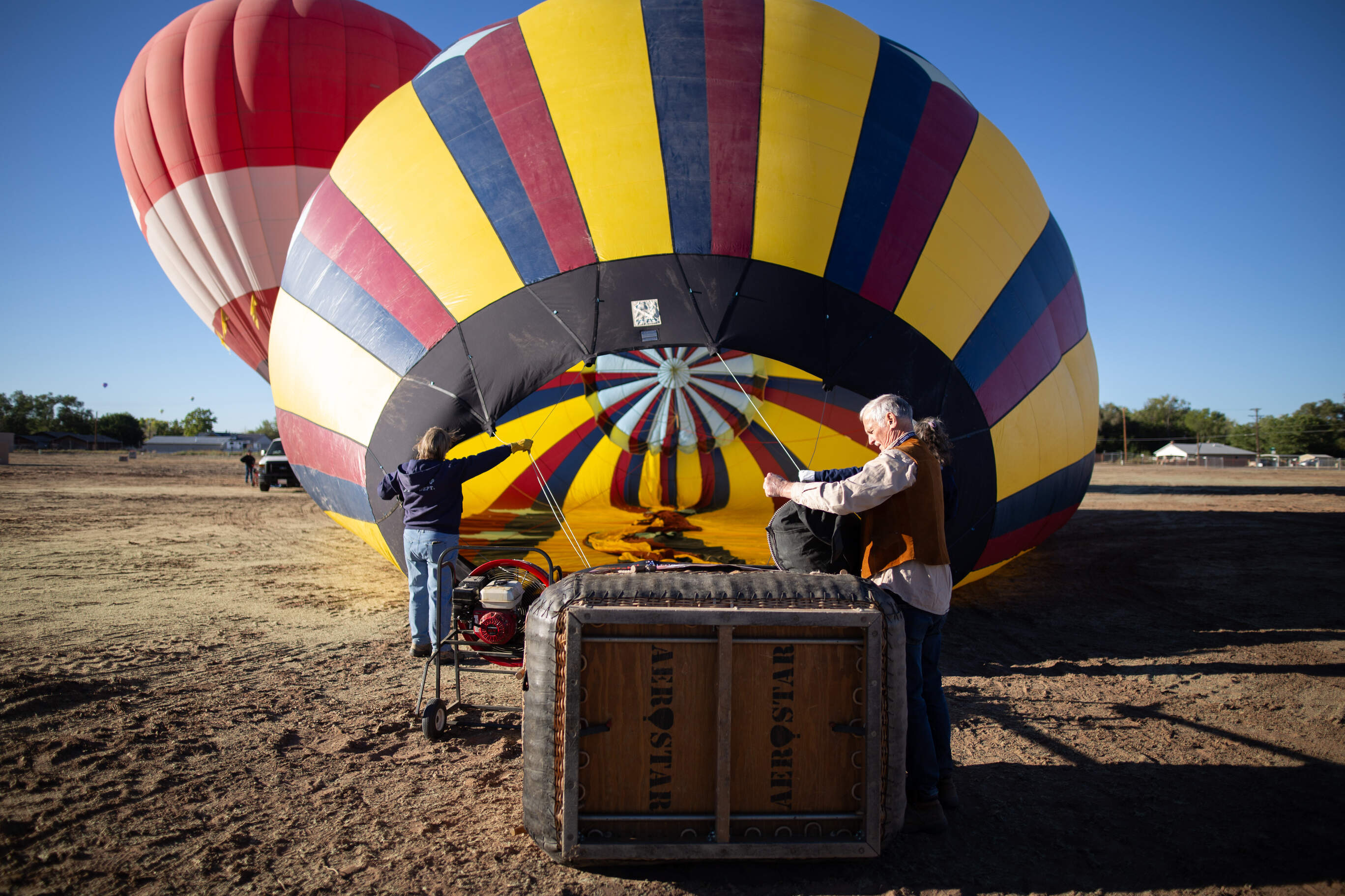 Pilot Gary Michalek checks on-board equipment while a noisy fan inflates his balloon. (Bryce Dix/KUNM)