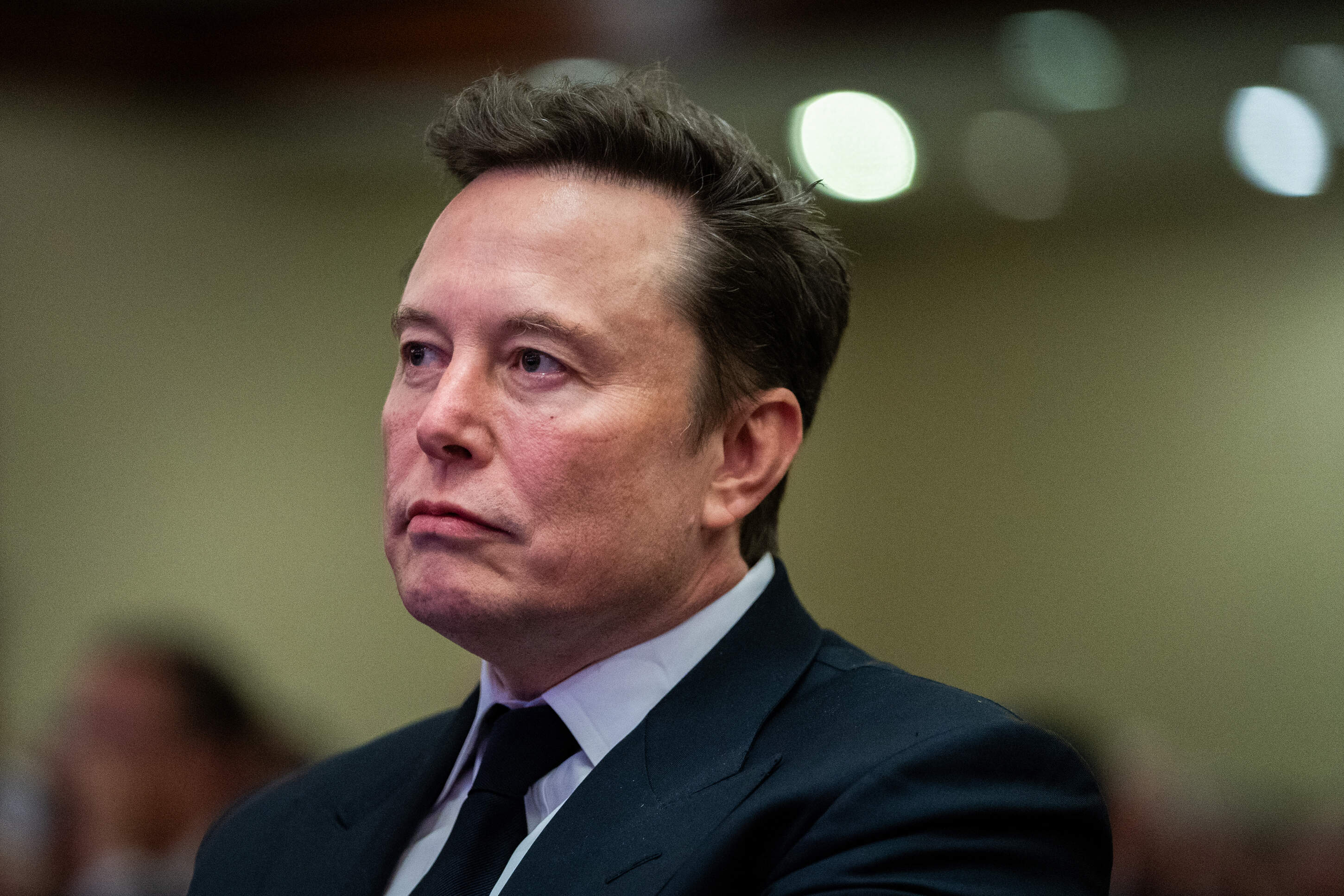 Elon Musk listens as U.S. President-elect Donald Trump speaks during a House Republicans Conference meeting at the Hyatt Regency on Capitol Hill on Nov. 13, 2024 in Washington, DC. (Allison Robbert-Pool/Getty Images)