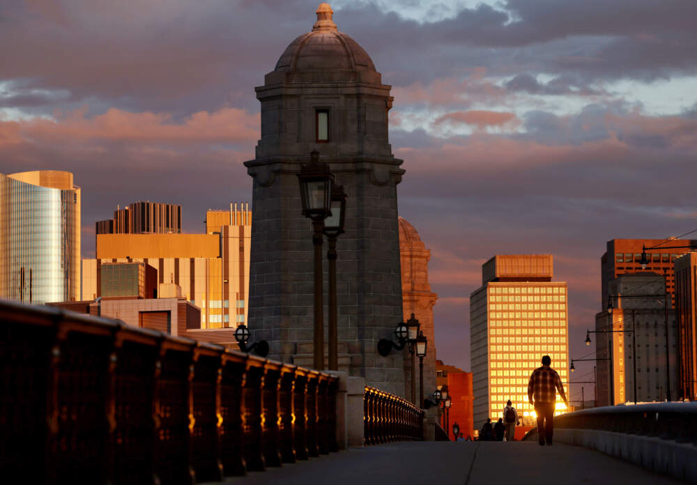 People cross the Longfellow Bridge at sunset. (Jessica Rinaldi/The Boston Globe via Getty Images)