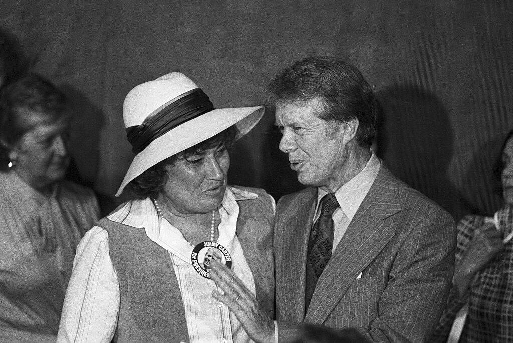 Jimmy Carter talks with New York Congresswoman Bella Abzug after meeting with representatives of a coalition of women's groups shortly after his arrival in Los Angeles. Carter promised the group more important roles for women in government and sufficient child care facilities if elected. (Getty Images)
