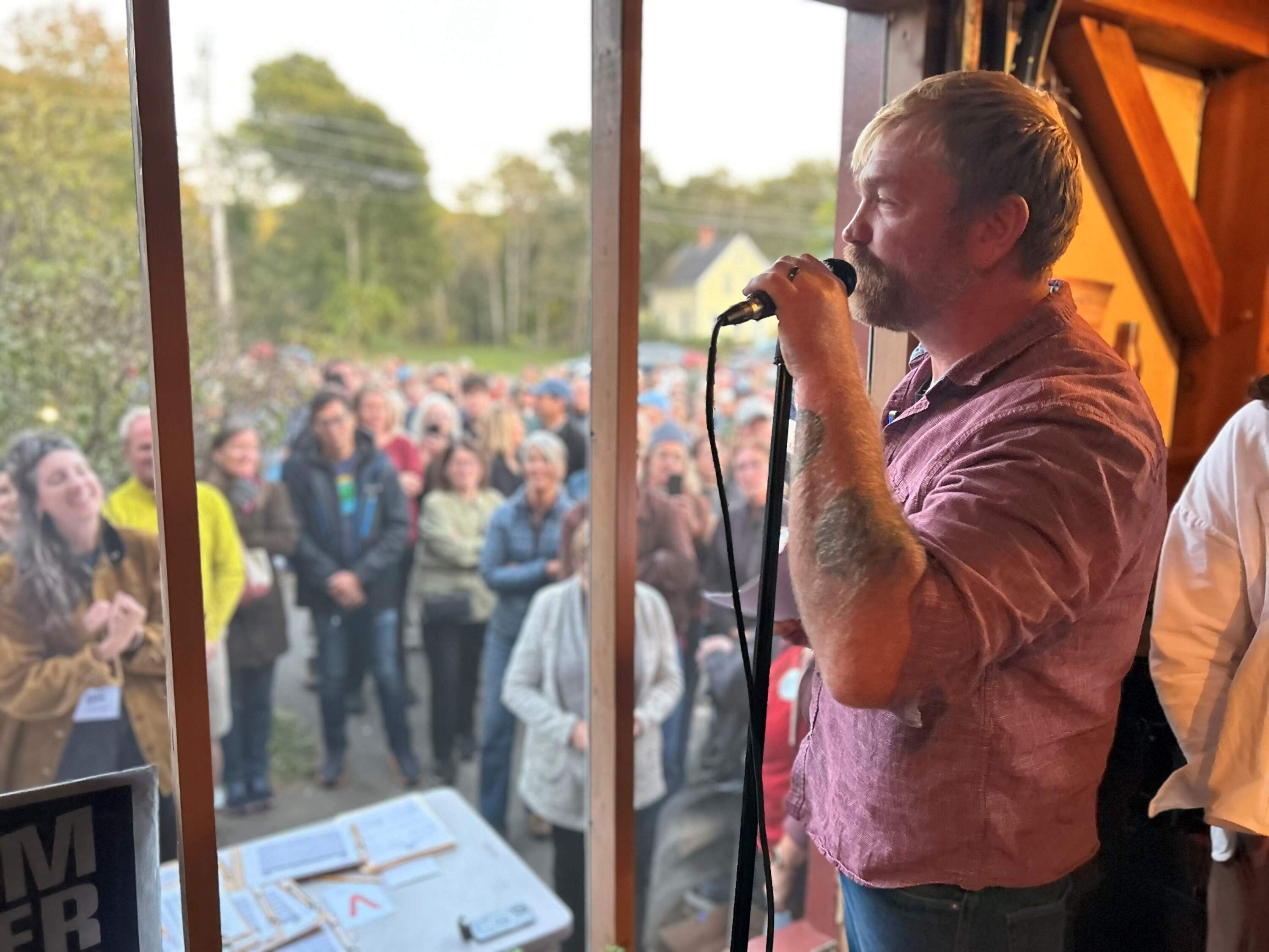 Graham Platner, Democratic candidate for U.S. Senate in Maine, address voters in Rockport. (Anthony Brooks/WBUR)