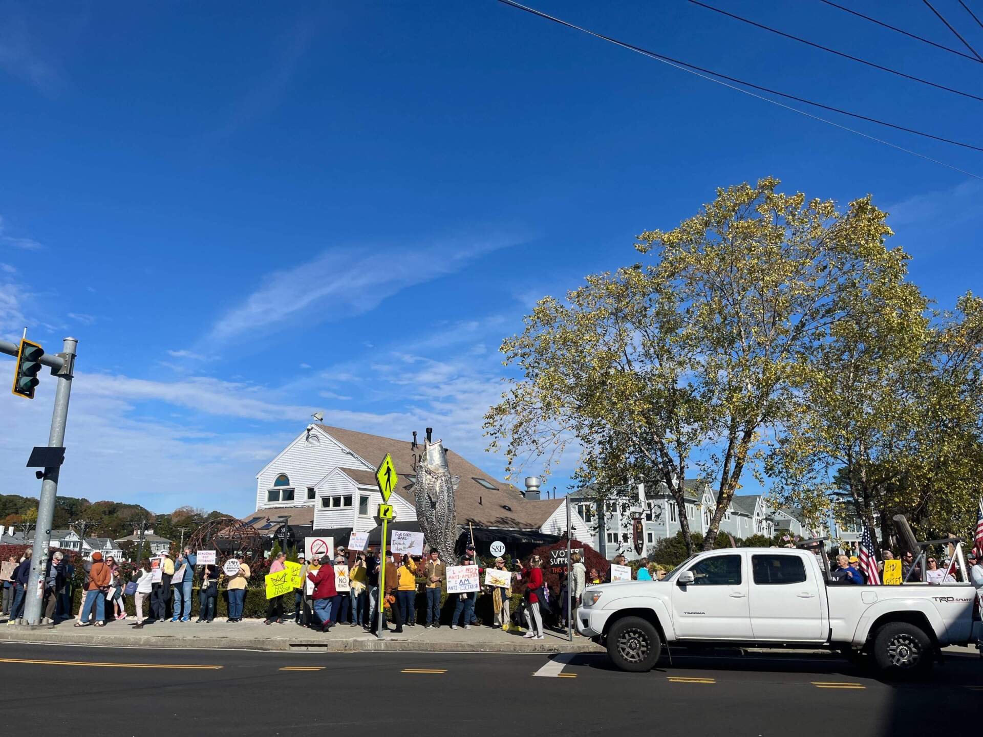 In Mystlc, Connecticut, demonstrators crowded both sides of the street. When boats went under the nearby bridge, they also honked their horns. (Amelia Mason/WBUR)