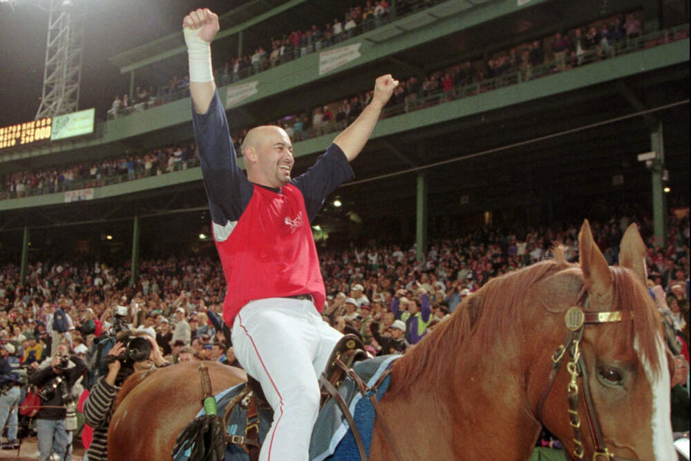Mike Greenwell cheers from atop a police horse while riding around Fenway Park in Boston, Wednesday, Sept. 20, 1995, after the Red Sox clinched the American League East Championship. (Winslow Townson/AP)