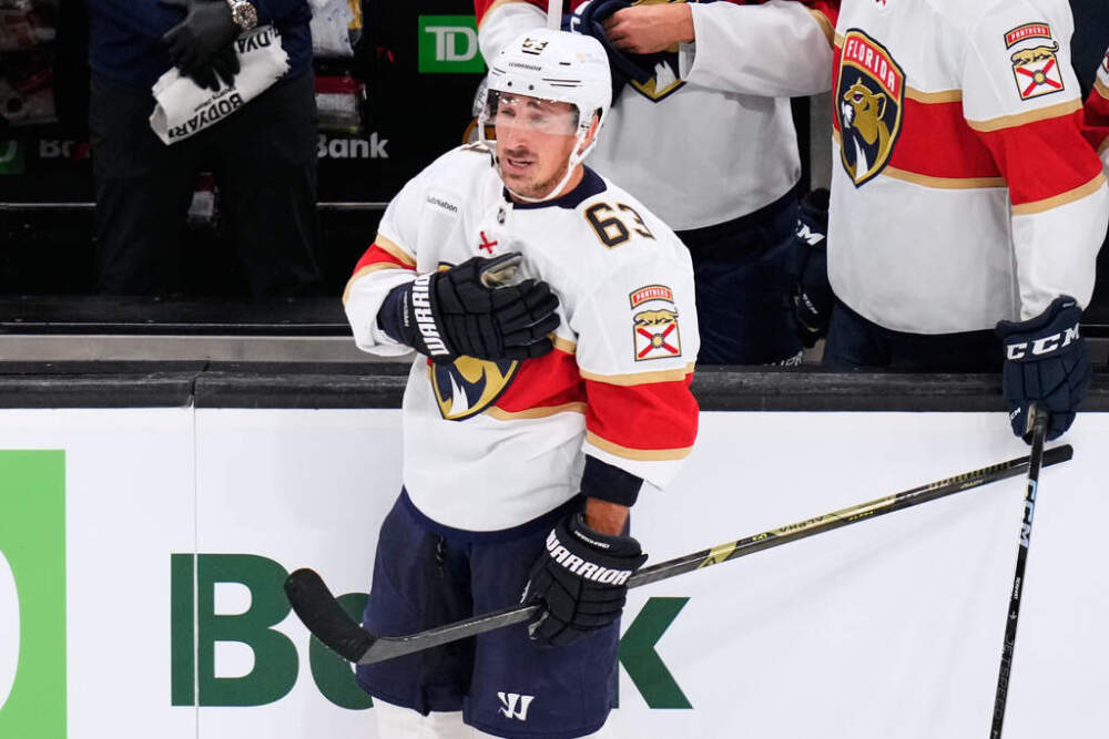 Florida Panthers left wing Brad Marchand (63) taps his heart during a standing ovation during a break in the first period of an NHL hockey game, Tuesday, Oct. 21, 2025, in Boston. (Charles Krupa/AP)