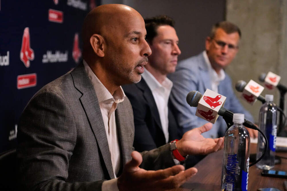 Boston Red Sox Manager Alex Cora, left, answers a reporter's question while seated with Chief Baseball Officer Craig Breslow, center, and President and CEO Sam Kennedy during a news conference at Fenway Park, Monday, Oct. 6, 2025. (Charles Krupa/AP)