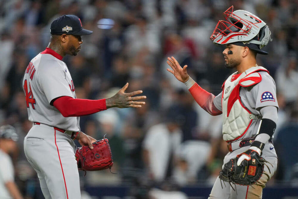 Boston Red Sox pitcher Aroldis Chapman, left, and catcher Carlos Narváez celebrate after defeating the New York Yankees in Game 1 of an American League wild-card baseball playoff series. (Yuki Iwamura/AP)