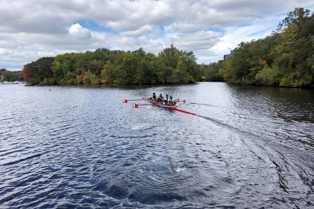 South African rowers, from left, Sheldon Krishnasamy, Lwazi-Tsebo Zwane, Lebone Mokheseng, and Sepitle Leshilo practice on the Charles River. (Rodrique Ngowi)