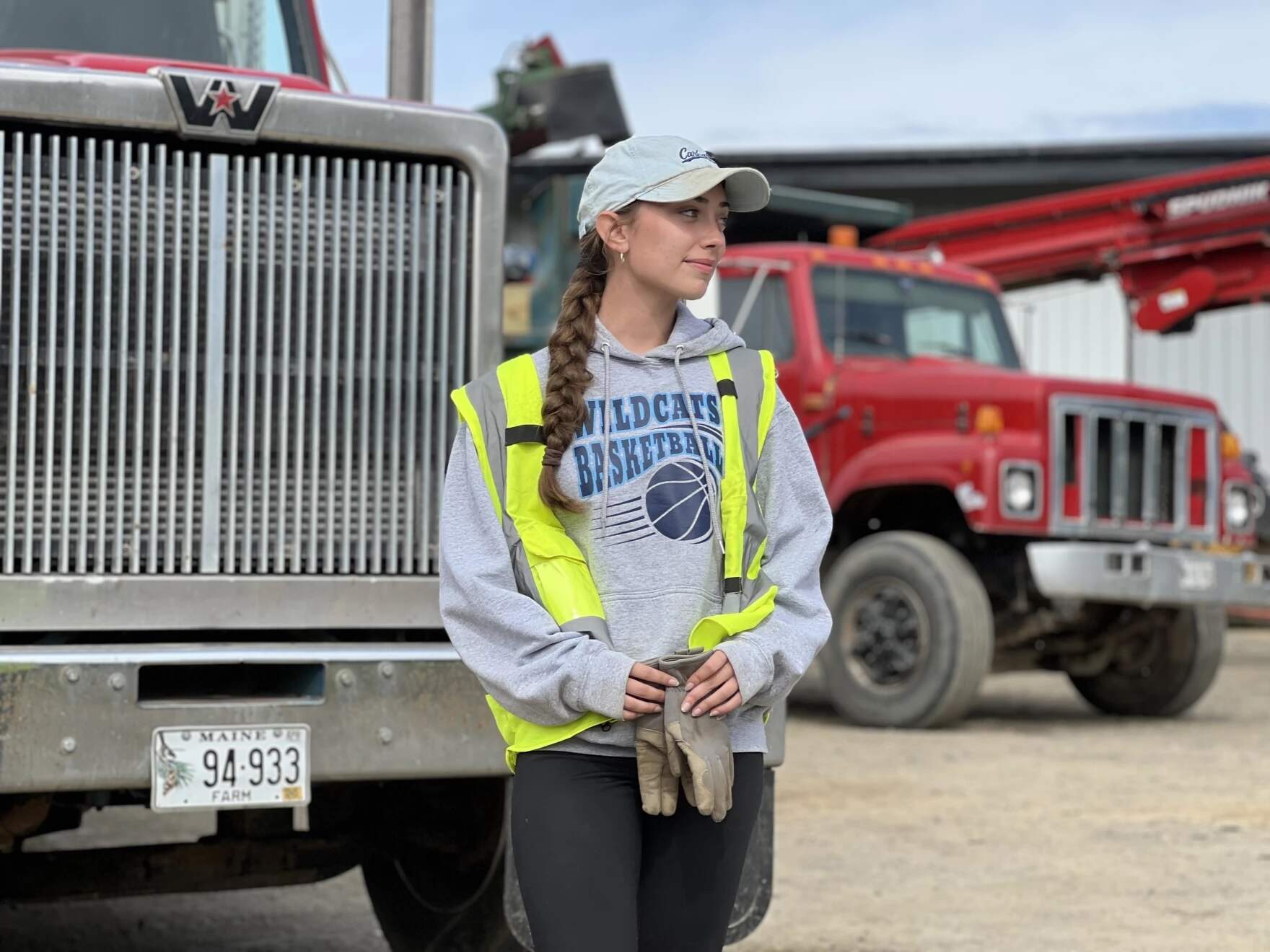 Maddie Putnam, 17, racks potatoes at Porter Farms for work during the annual harvest break. She says she'll likely save her $19-per-hour wage for college or spend it on gas for her car. (Michael Livingston/Maine Public)