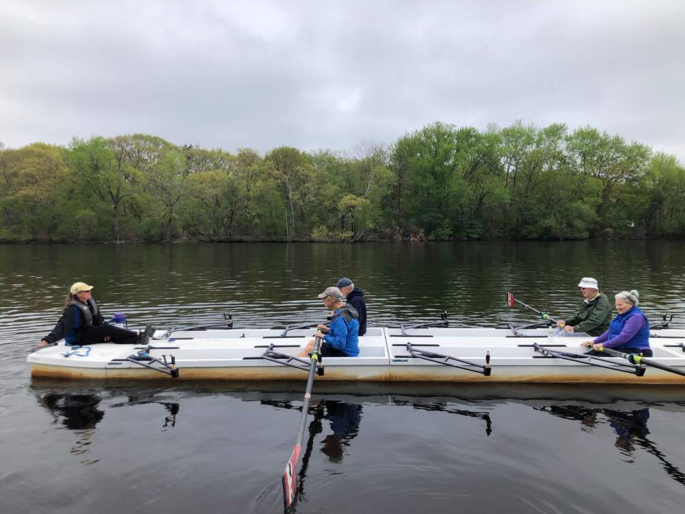 Frank Lynch, sitting in the back right, on his first day on the water rowing on the barge with CRI. Boston, 2025. (Courtesy Caitrin Lynch)
