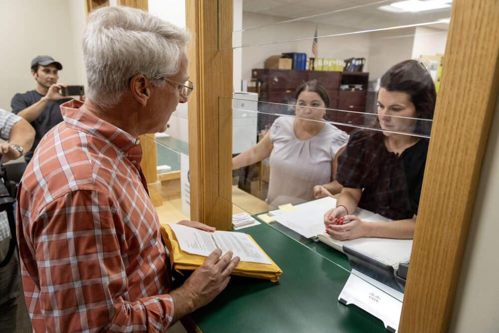In this file photograph from September, Steve Perdios, with the group Quincy Citizens for Fair Raises, submitted resident signatures at City Hall in an effort to put the question of the mayor's salary on the ballot. The city clerk rejected more than a third of the signatures. Perdios is now among a group of Quincy residents suing the city for shooting down that effort. (Robin Lubbock/WBUR File)