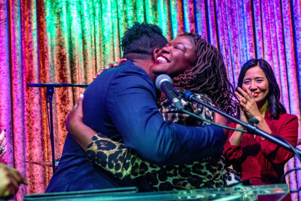 Incumbent At-Large City Councilors Ruthzee Louijeune and Henry Santana embrace on election night. (Jesse Costa/WBUR)