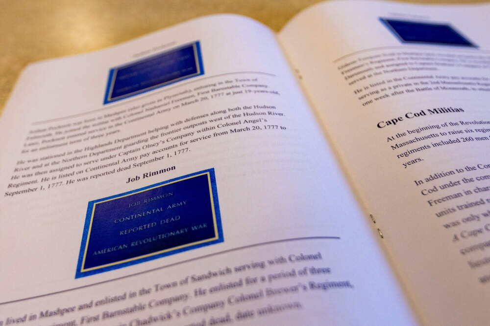 Photos of memorial plaques and corresponding research on Mashpee Wampanoag soldiers who died in the Revolutionary War feature in "The Ultimate Sacrifice: Mashpee in the American Revolution." (Jesse Costa/WBUR)