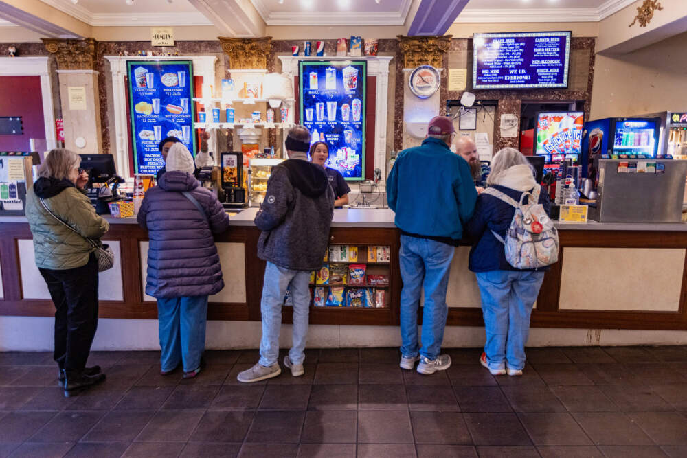 The matinee crowd purchase food and drinks before the show at the concession stand at the Capitol Theatre in Arlington. (Jesse Costa/WBUR)