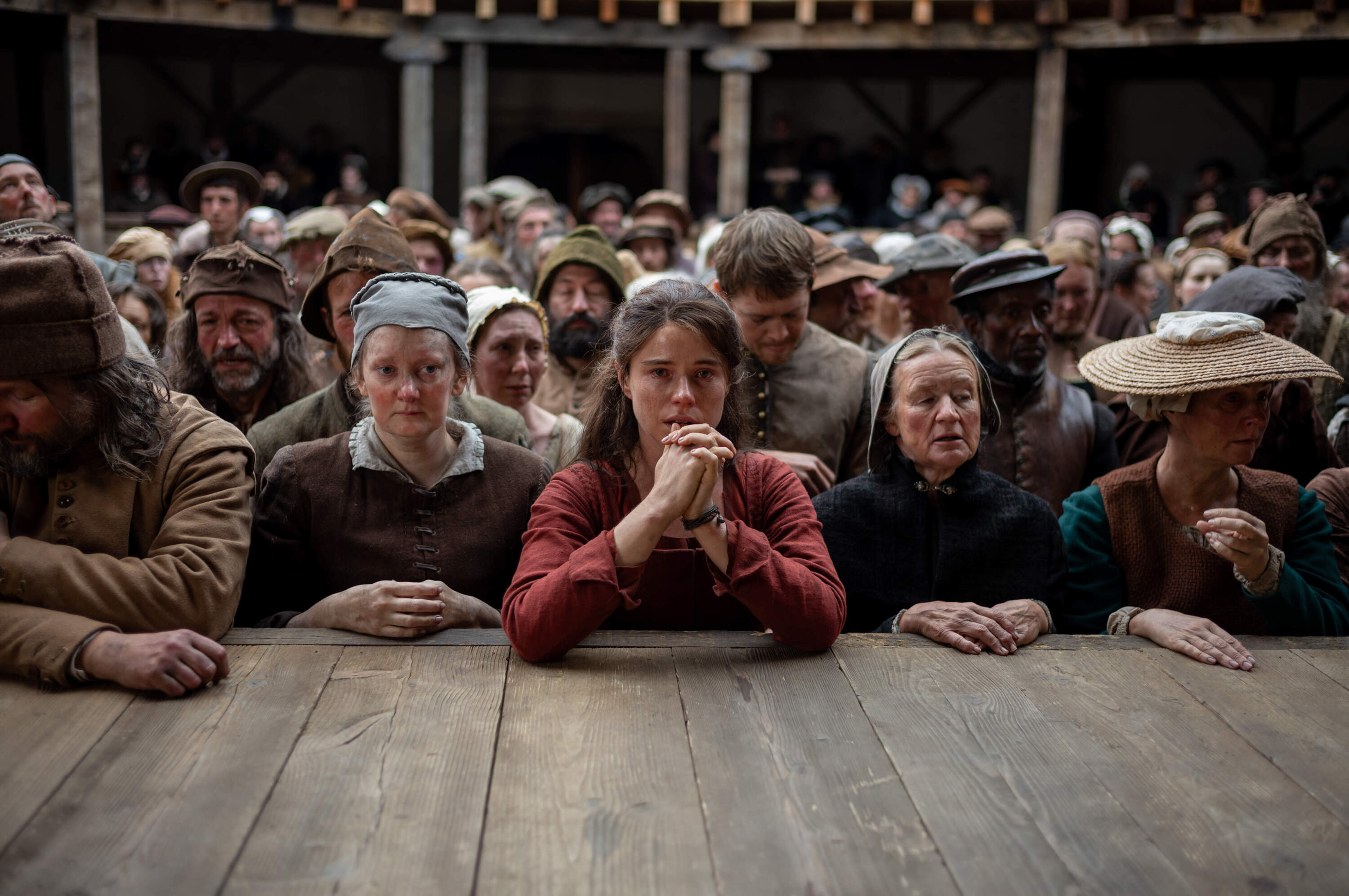 Jessie Buckley as Agnes (center) in director Chloé Zhao’s "Hamnet." (Courtesy Agata Grzybowska/Focus Features)