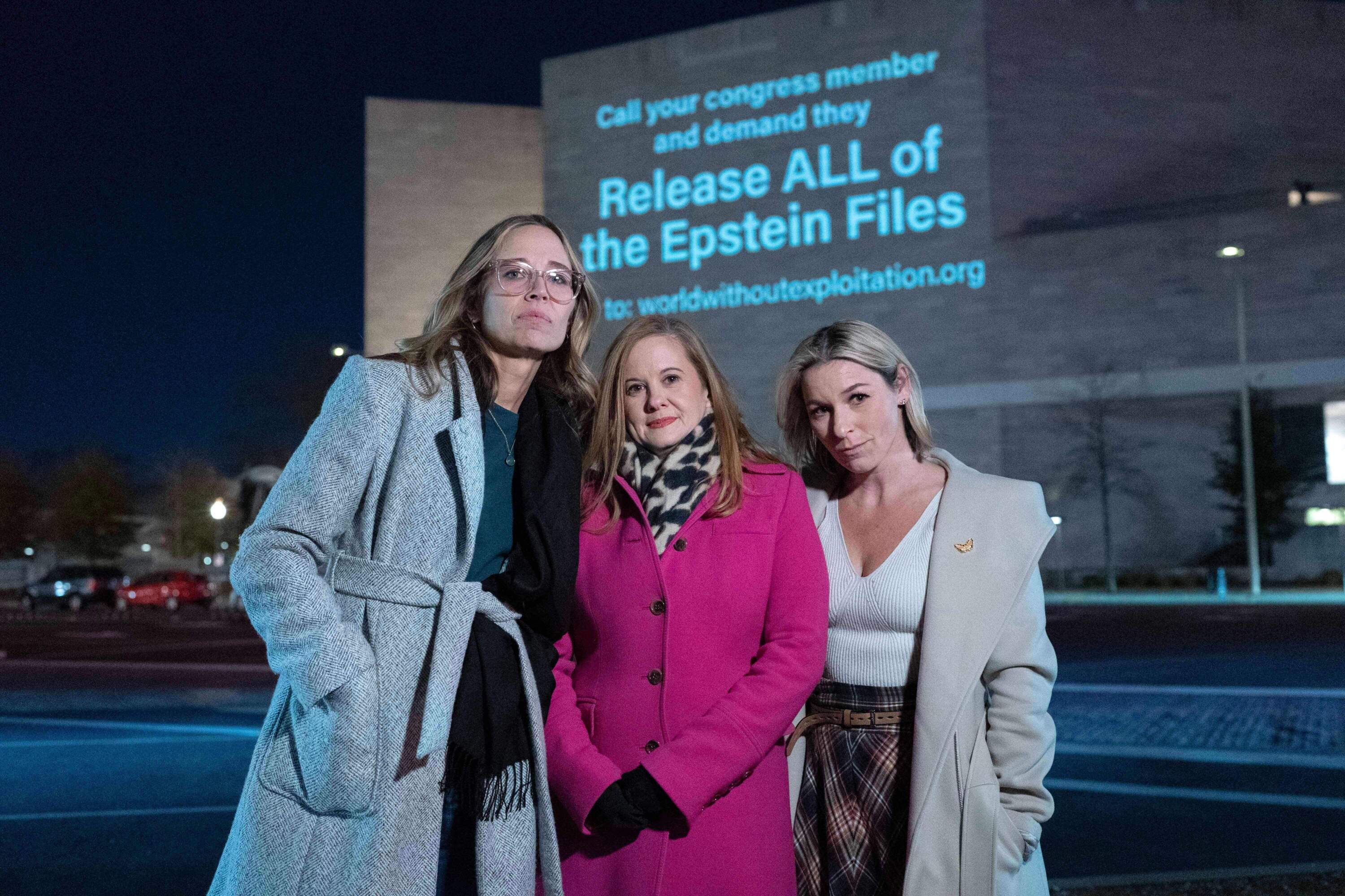 Annie Farmer, from left, Liz Stein and Danielle Bensky pose for a photo as a World Without Exploitation projection is seen on the wall of the National Gallery of Art calling on Congress to vote yes on the Epstein files transparency act in Washington, Monday, Nov. 17, 2025. (Jose Luis Magana/AP)