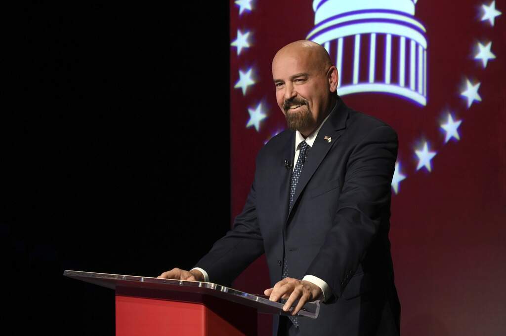 Republican Senate candidate John Deaton stands at a podium before the start of a debate against Sen. Elizabeth Warren in Springfield, Mass., Thursday, Oct. 17, 2024. (Meredith Nierman/Pool Photo via AP)
