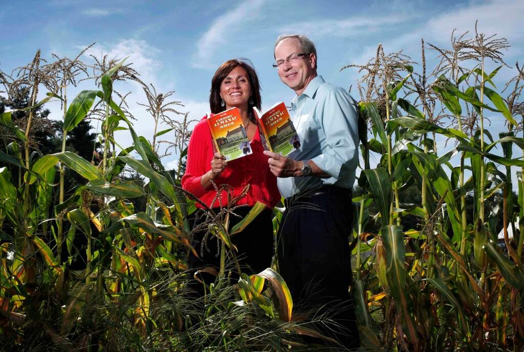 Farmers' Almanac editor Sondra Duncan and publisher Peter Geiger pose in a corn field with the 2012 edition of the almanac, Aug. 24, 2011, in Auburn, Maine. (Robert F. Bukaty/AP File)