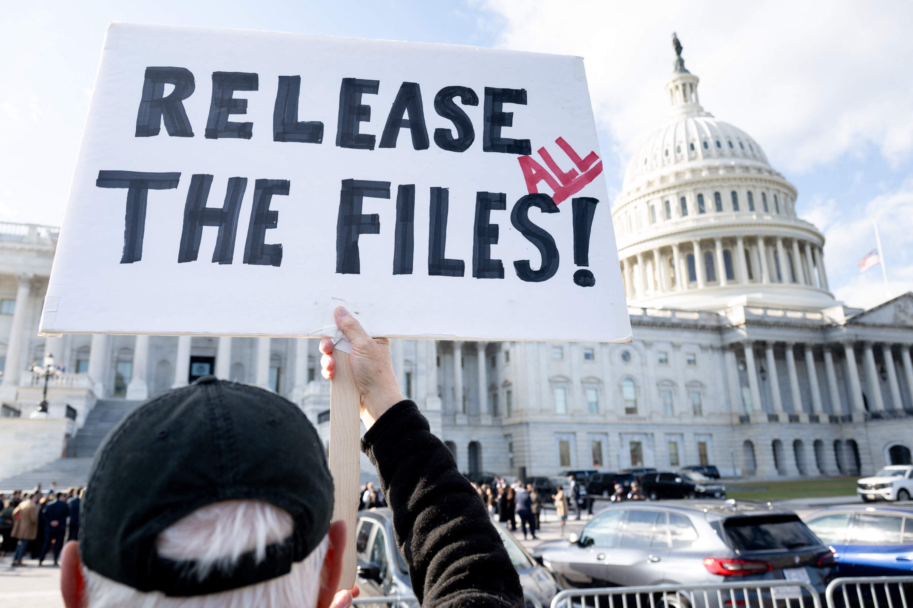 A protester holds a sign related to the release of the Jeffrey Epstein case files outside the US Capitol in Washington, DC, Nov. 12, 2025. (Saul Loeb/AFP via Getty Images)