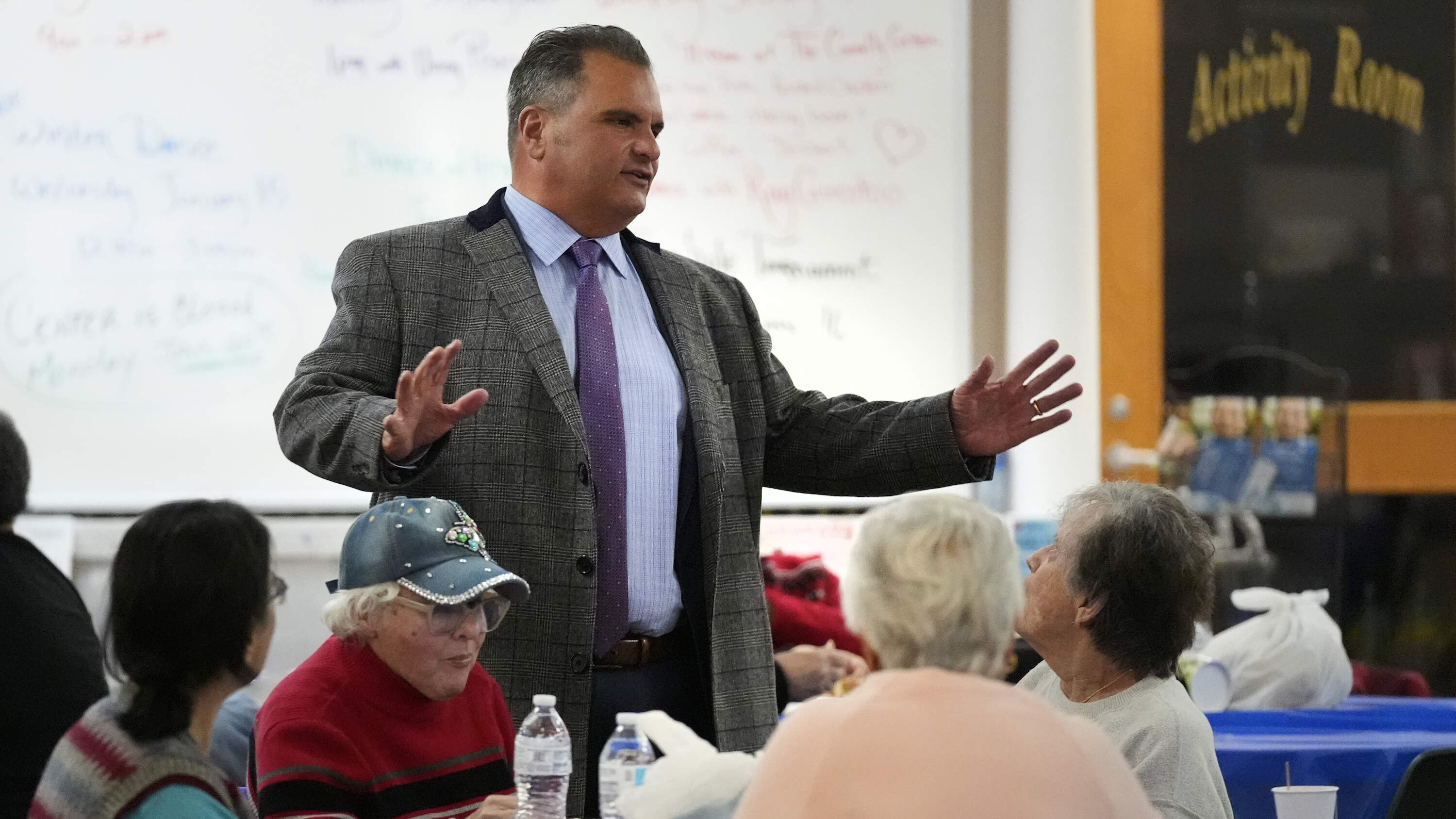 Everett Mayor Carlo DeMaria talks with guests while visiting a senior luncheon following a bingo game on Jan. 13, 2025.