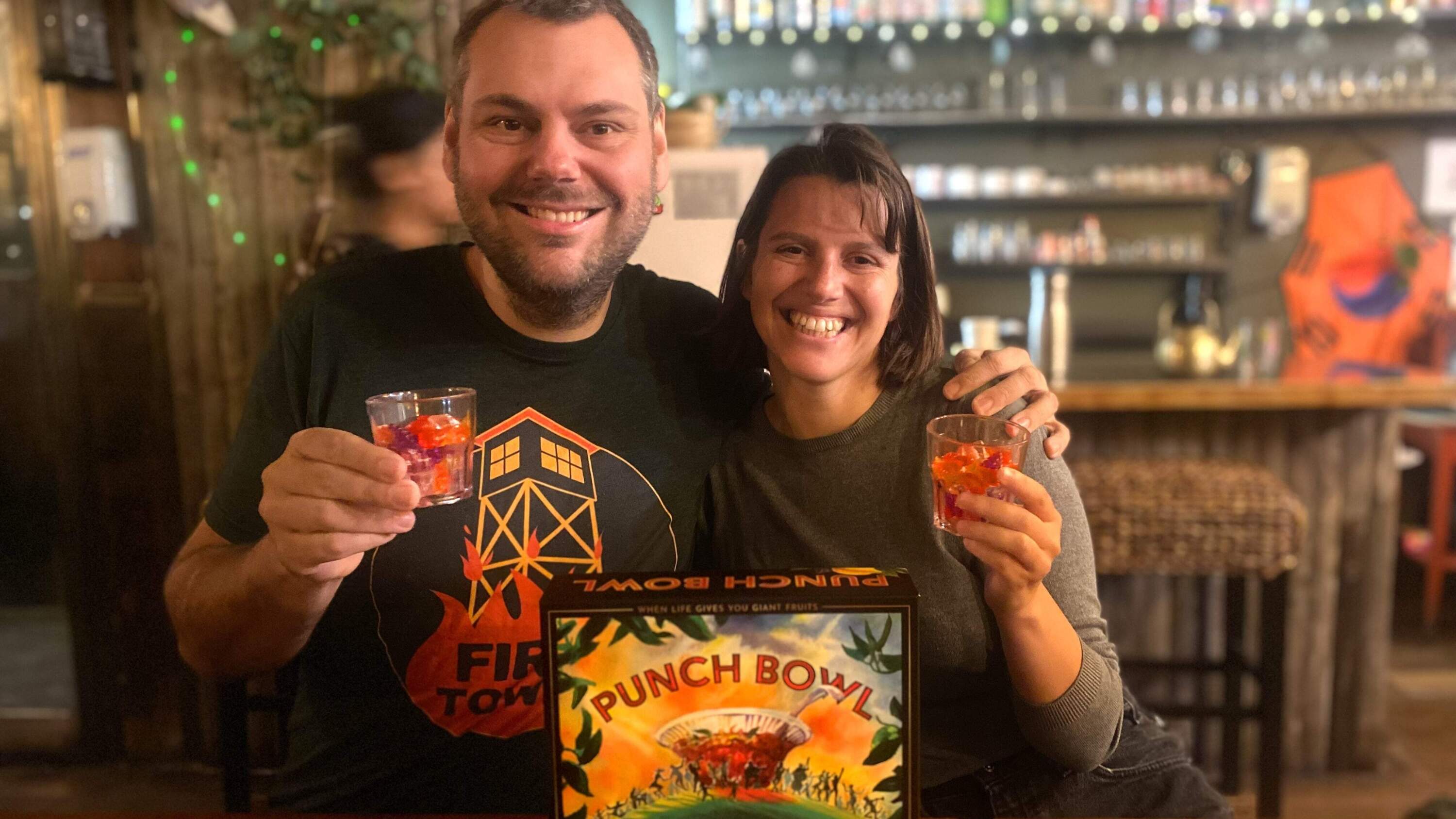 Sam Bryant and Gwen Ruelle pose with their newest board game, Punch Bowl. (Courtesy of Runaway Parade Games)