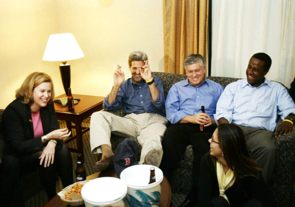 Then- Democratic Presidential candidate Sen. John Kerry crosses his fingers as he watches the third inning of the Red Sox vs. Yankees ALCS game seven with members of his campaign staff, including Setti Warren on the far right, Oct. 20, 2004. (Gerald Herbert/AP file)
