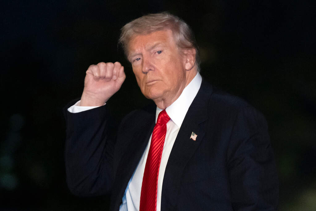 President Donald Trump gestures while walking across the South Lawn of the White House, Sunday, Nov. 2, 2025, in Washington, after returning from a trip to Florida. (AP Photo/Mark Schiefelbein)