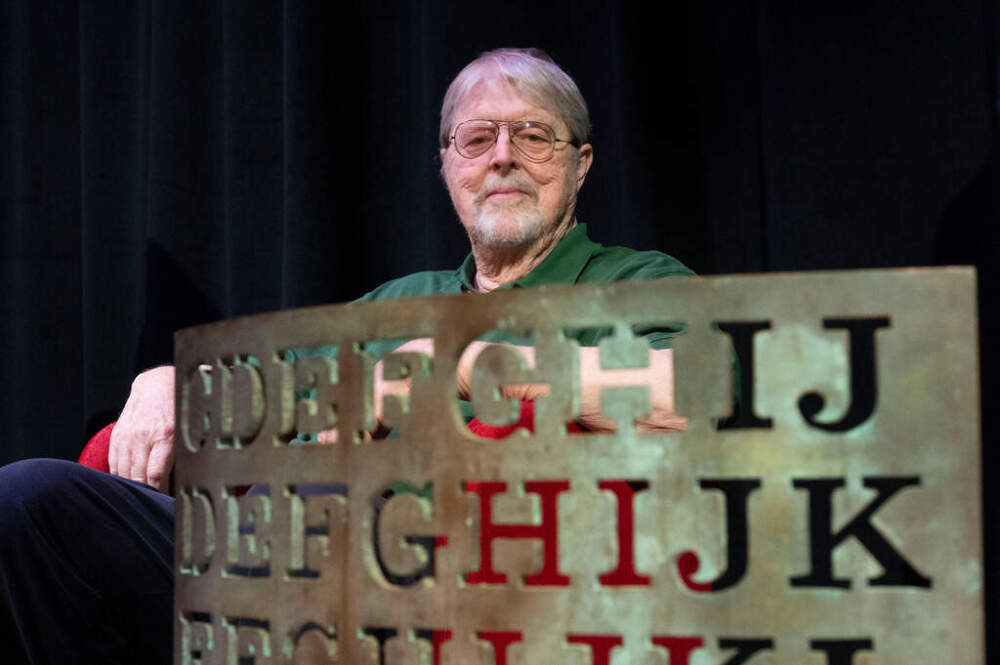Artist Jim Sanborn sits behind a proof of concept piece for the Kryptos sculpture during a press conference at the International Spy Museum, Wednesday, Nov. 12, 2025 in Washington. (Kevin Wolf/AP)