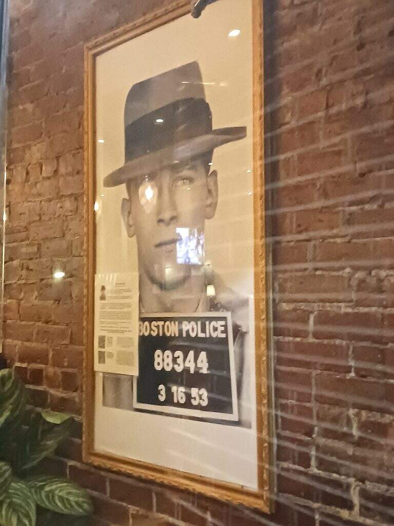 Whitey Bulger’s picture as seen through the front door of Savin Bar + Kitchen in October. (Seth Daniel/Dorchester Reporter)
