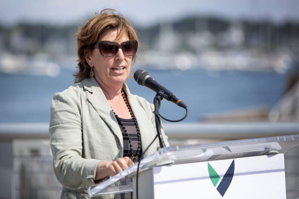 Massachusetts Energy and Environmental Affairs Secretary Rebecca Tepper welcomes a wind turbine installation vessel to Salem Harbor. (Robin Lubbock/WBUR)