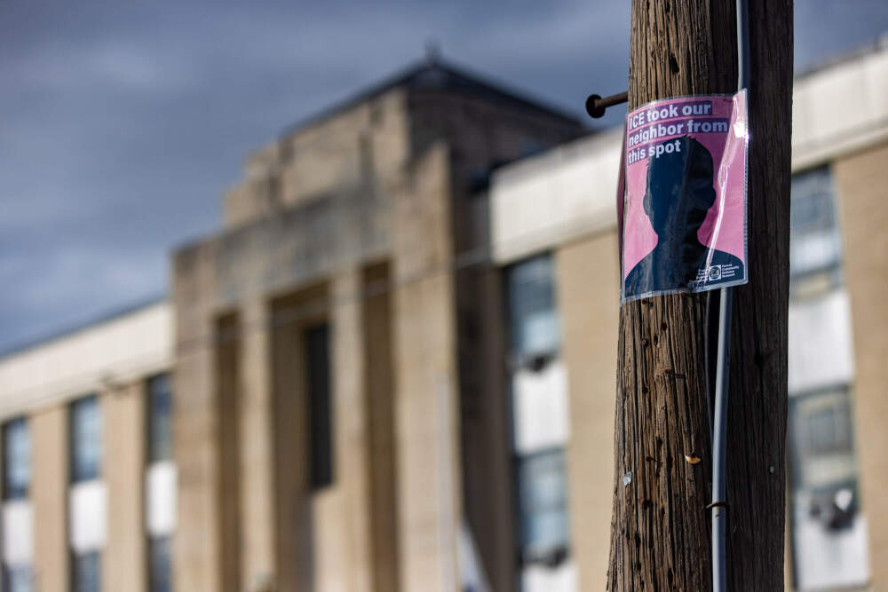 A poster from the Fuerza Community Defense Network on a telephone outside of Waltham District Court warning people of the potential presence of ICE at the courthouse. (Jesse Costa/WBUR)