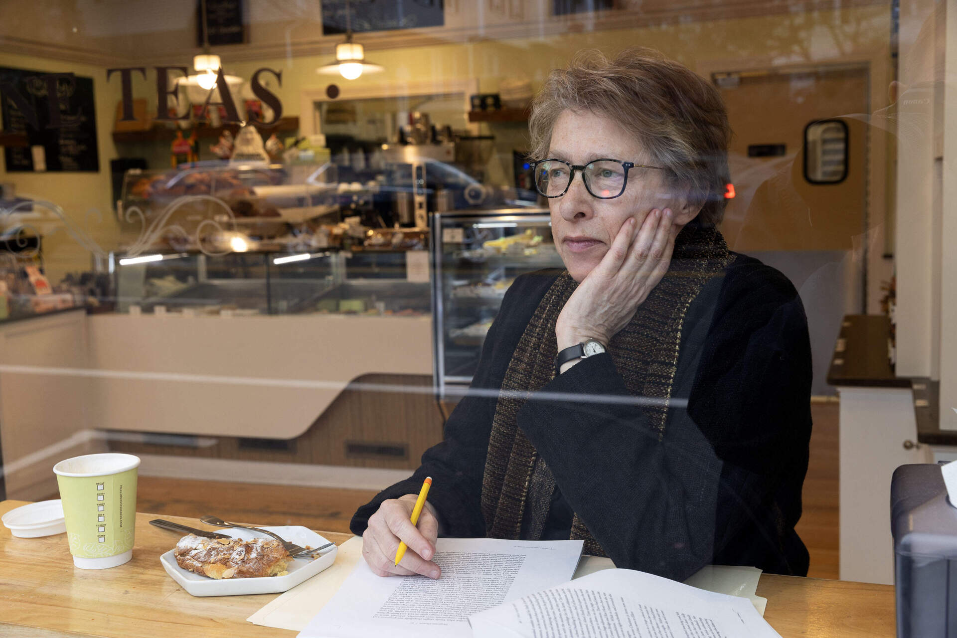 Biographer Megan Marshall looks across Belmont Street from the window of Praliné French Patisserie's location in Belmont, Mass. (Robin Lubbock/WBUR)