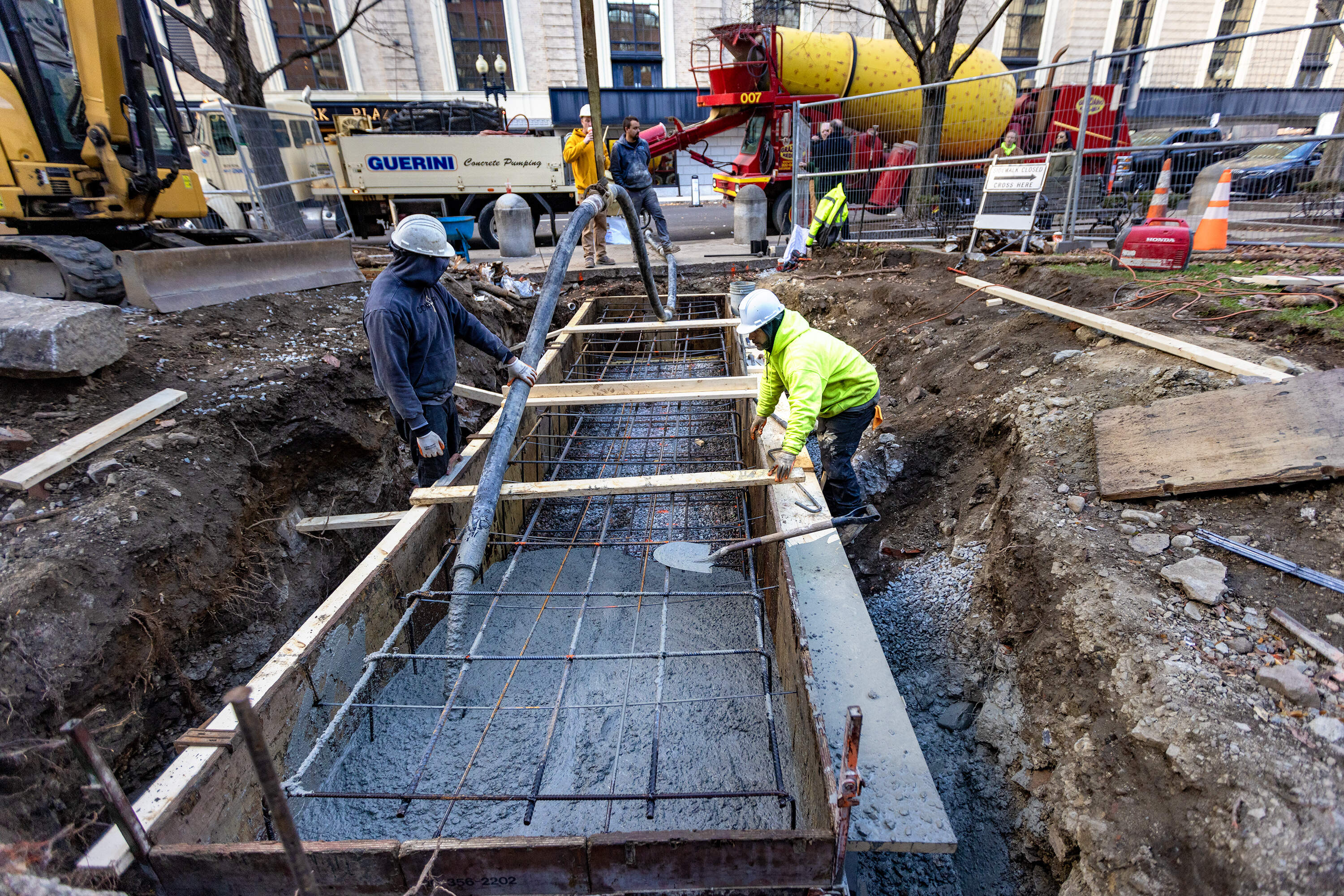 A construction crew pours cement for the foundation of the Cocoanut Grove Memorial in Statler Park. (Jesse Costa/WBUR)