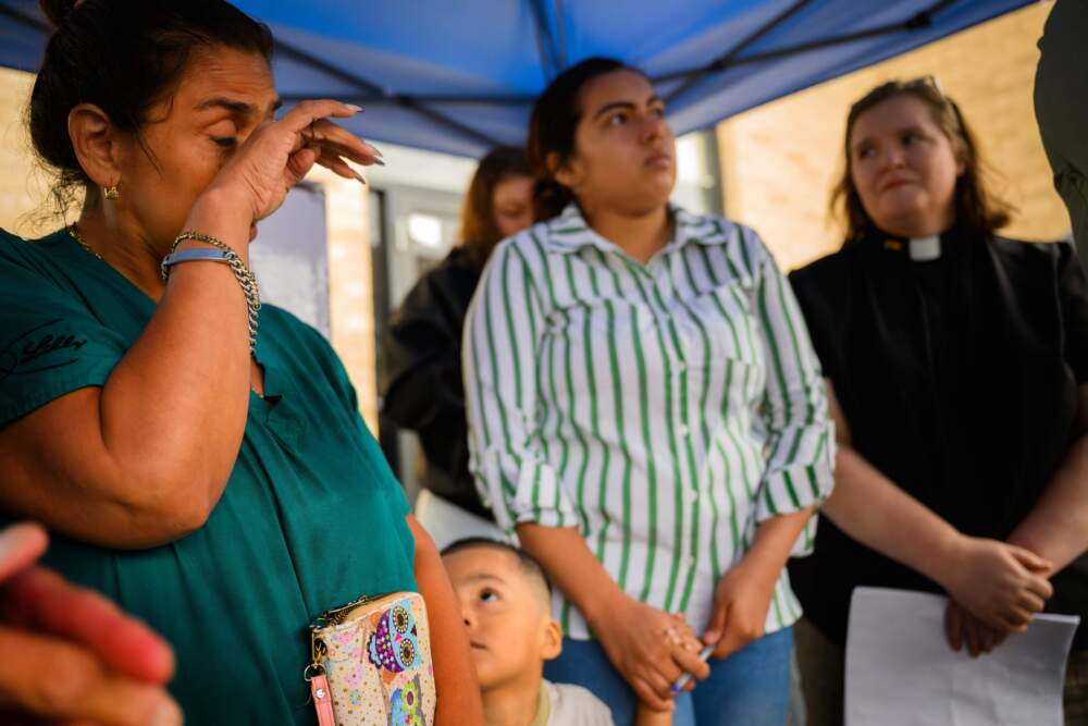 Jossie Gutierrez wipes tears after speaking at a Danbury, Conn. rally about ICE taking her partner, Edwin Andres Calva-Guaman, into custody at the Danbury Superior Courthouse. Gutierrez said in Spanish that Calva-Gauman is the main provider for his sister, his nephews and his mother who is back in their home country of Ecuador. (Mark Mirko/Connecticut Public)