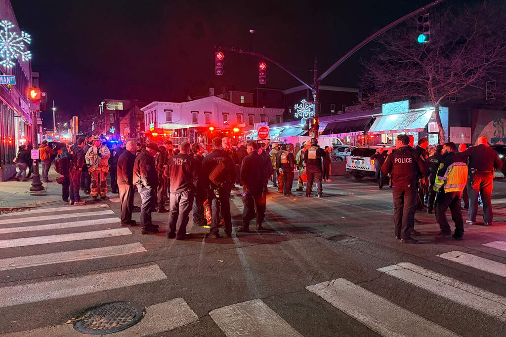 Police officers and first responders gather at Waterman St. and Thayer in response to a shooting in Providence, R.I. on Saturday night. (Jen McDermott/AP)