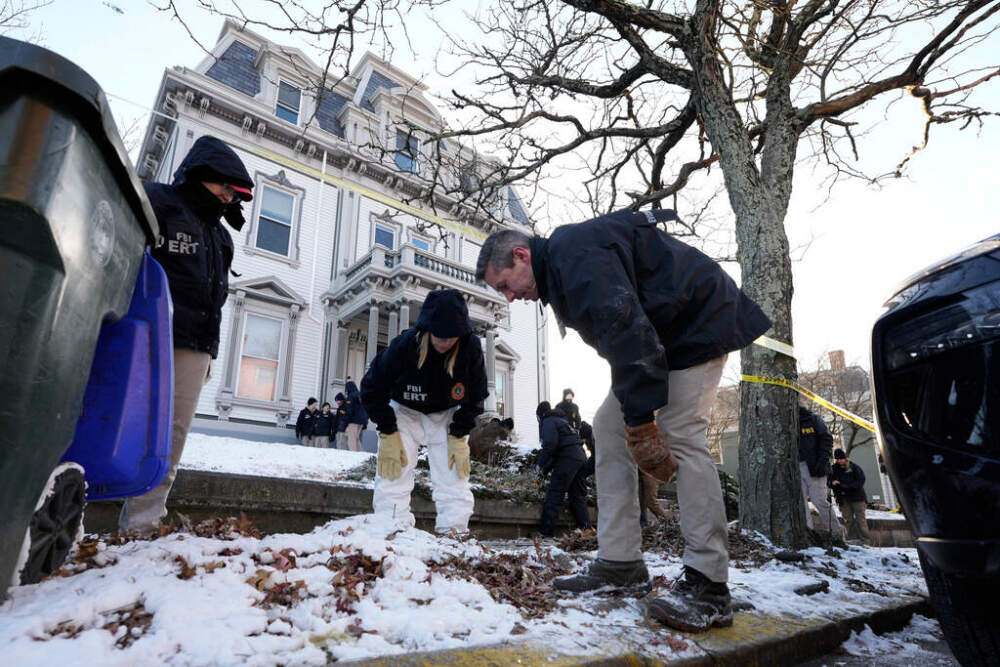 Members of the FBI Evidence Response Team search for evidence near Brown University campus on Monday. (Robert F. Bukaty/AP)