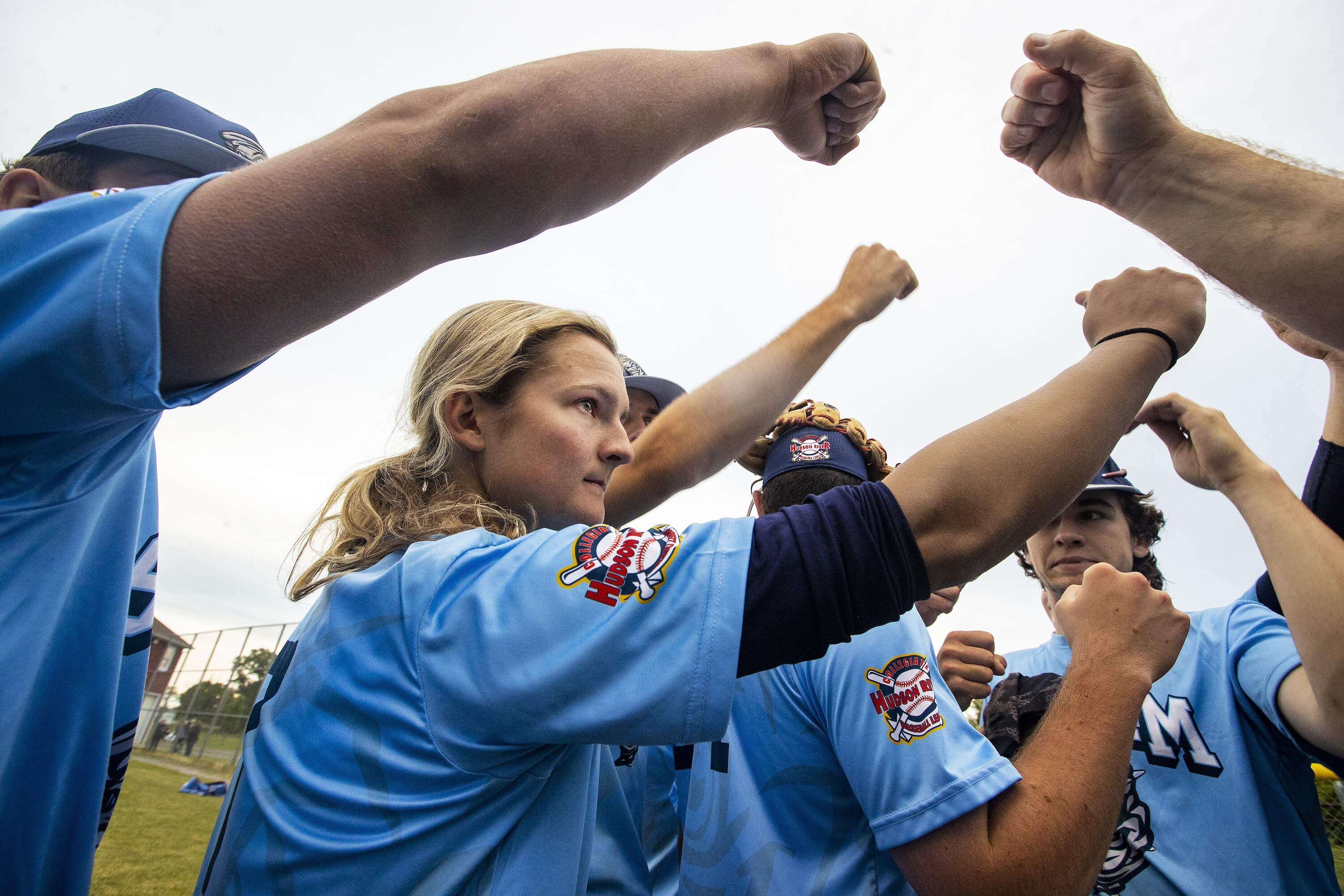 Beth Greenwood, a catcher for the Storm in the Hudson River Collegiate Baseball League, fist bumps teammates after a win in 2022. (Stan Grossfeld/The Boston Globe via Getty Images)